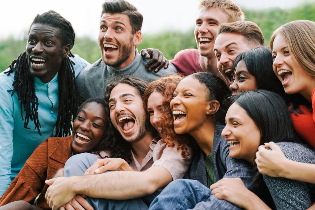 Multiethnic happy group of people having fun outdoor - Focus on center African girl